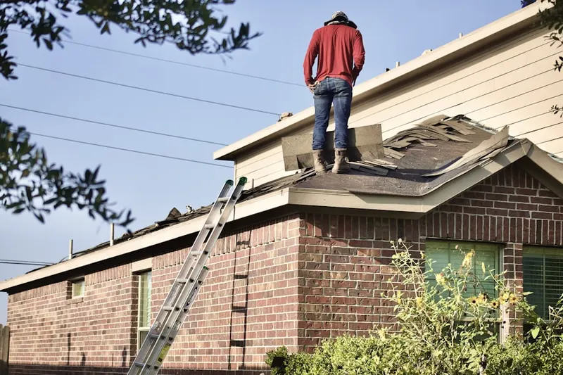 Professional roofer working on a residential roof in Danboro